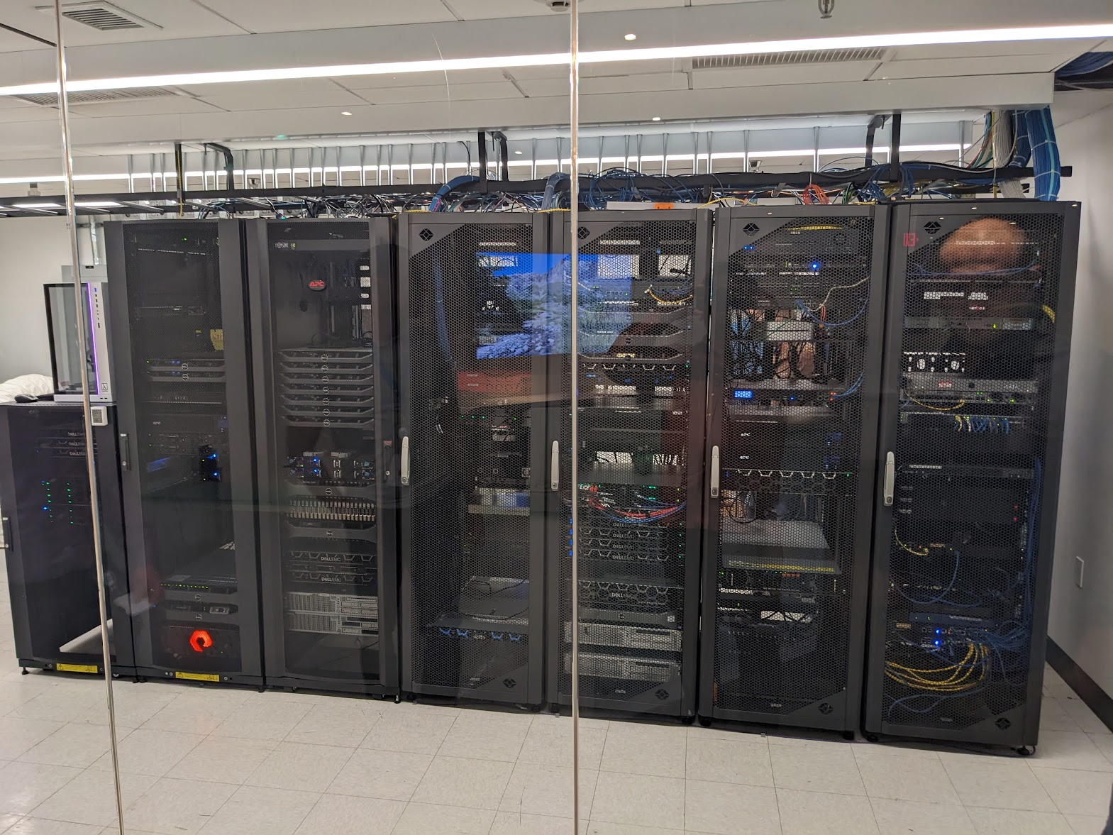 View of Quansight's server setup at MetroStar's data center, showing multiple server racks and equipment